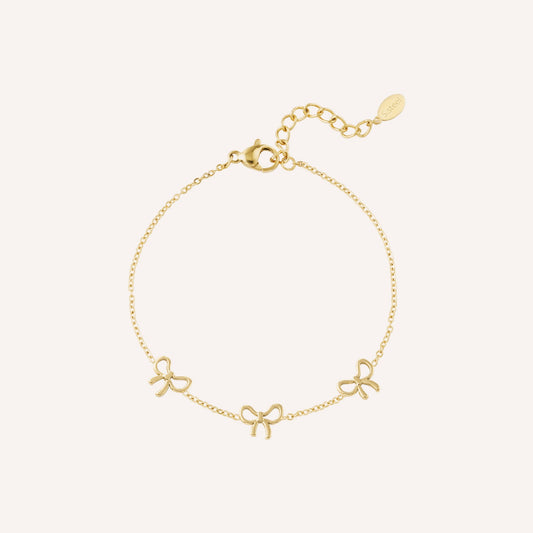 Ponza Armband, goudkleurige bedelarmband met strikjes